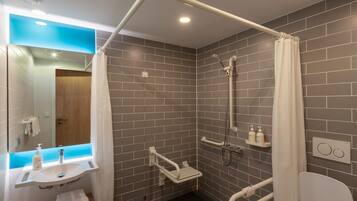 A modern bathroom with a shower, toilet, and sink.