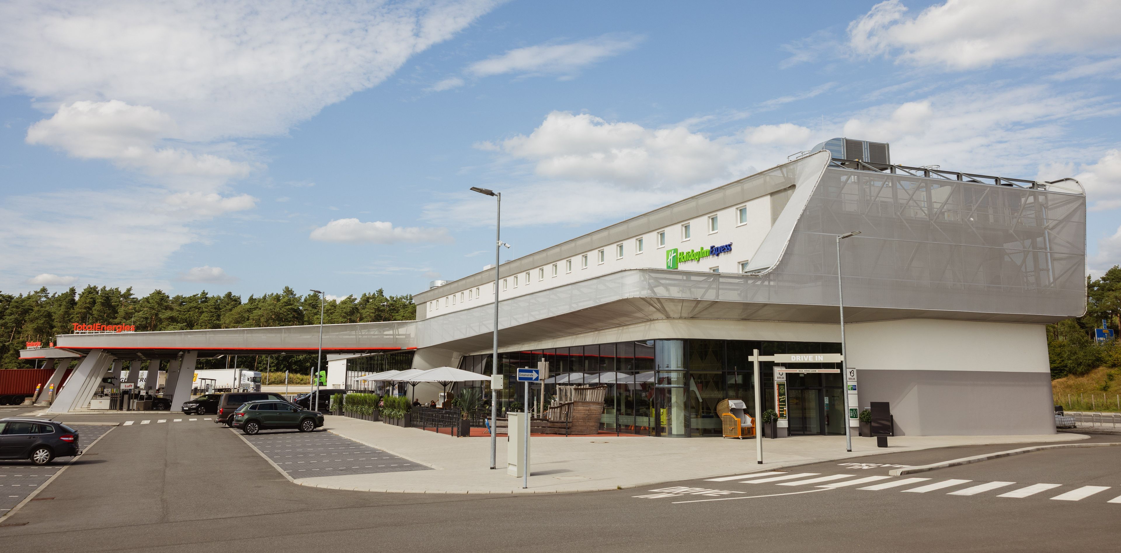 A modern building with a flat roof and a large entrance.