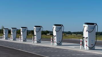 A row of electric vehicle charging stations along a road.