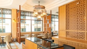 A modern interior with a reception desk, seating area, and decorative wooden panels. - Peacock De Pai Hotel (Pai)