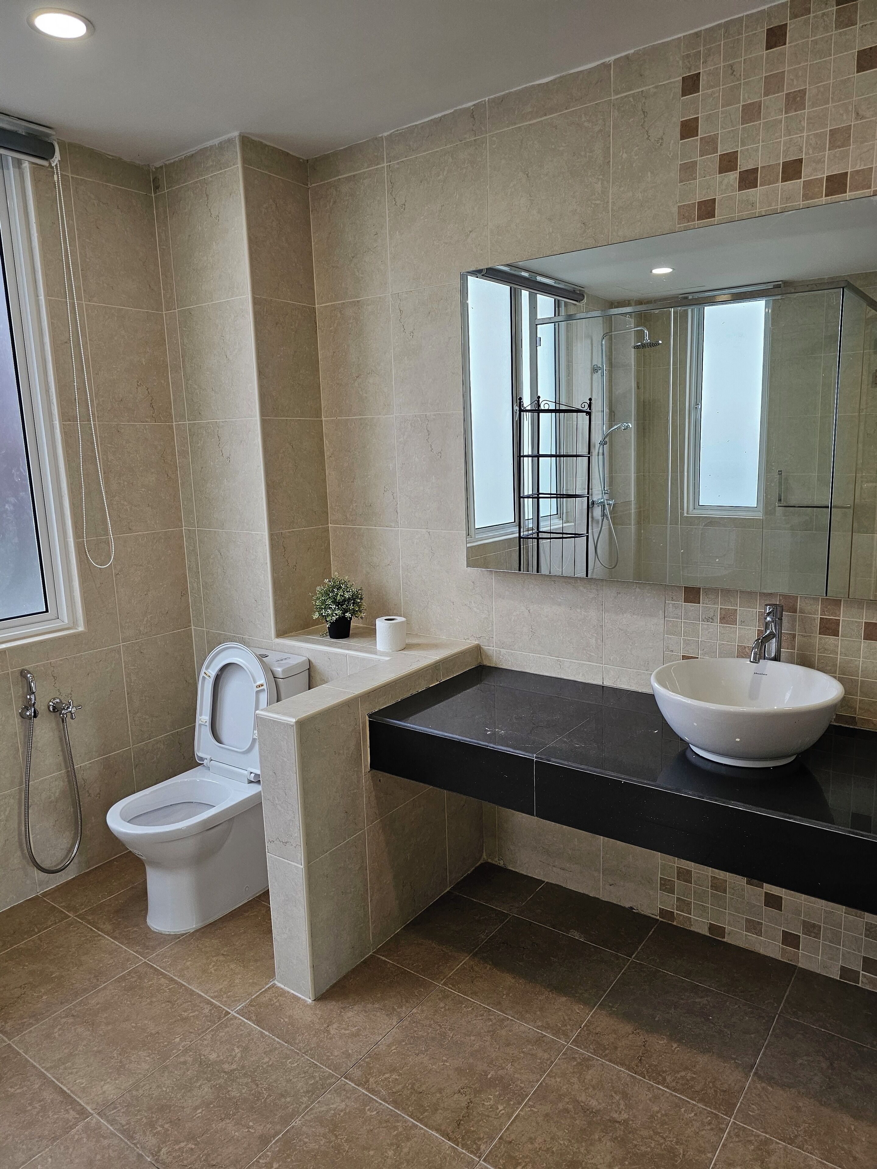A modern bathroom with a toilet, bidet, and sink.