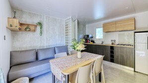 A modern kitchen with a built-in stove, a microwave, and a refrigerator.