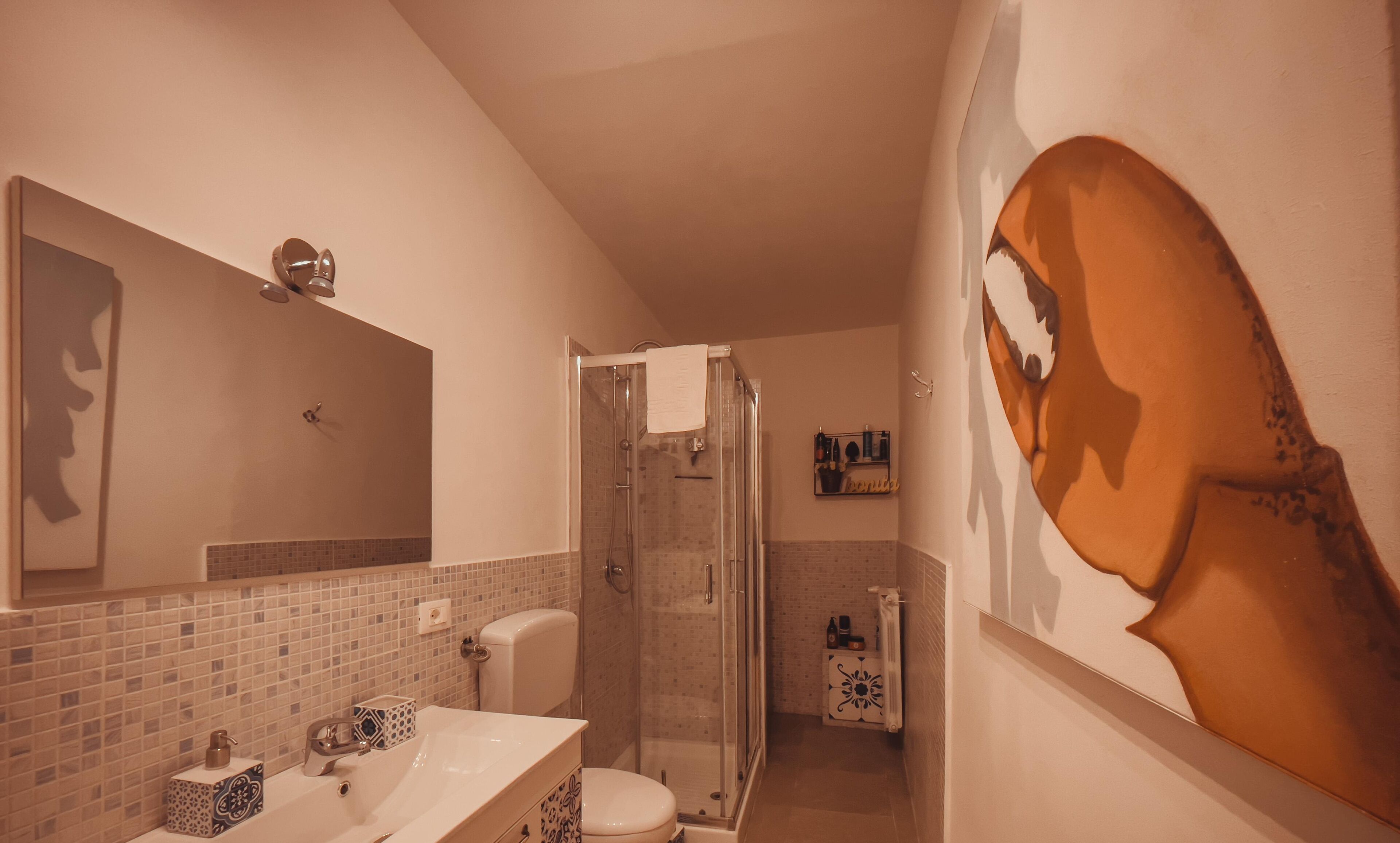 A bathroom with a shower, toilet, and sink.
