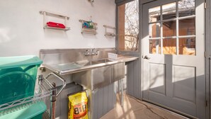 A kitchen with a sink, a dish rack, and a bag of charcoal. - Contemporary Style with Old World Charm (Santa Fe)