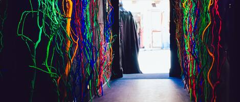 Un pasillo con coloridas instalaciones de luz abstractas en las paredes.