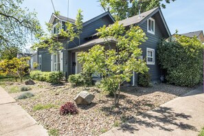 A two-story residential house with a front yard, a small tree, and a rock. - A beautiful home near OSU campus (Corvallis)