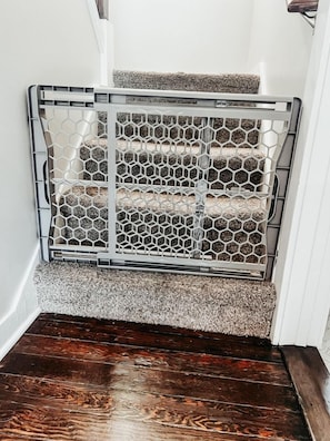 A staircase with a metal railing and a textured carpet. - A beautiful home near OSU campus (Corvallis)