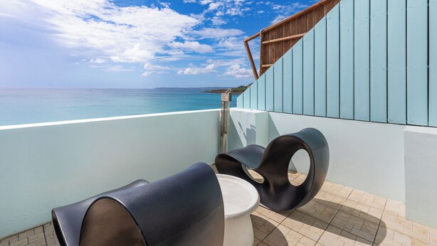 A balcony with a view of the ocean, a wooden railing, and two modern chairs. - Jhai-Wu (Hengchun)
