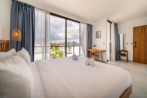 Une chambre d’hôtel avec un grand lit, un bureau, une chaise et une vue sur l’extérieur.