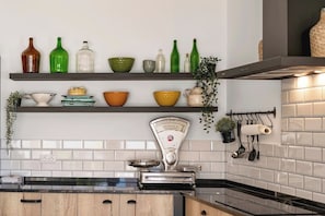 A kitchen with white tiled backsplash, wooden cabinets, and a stainless steel scale. - Casa dos Netos - villa with private pool (São Bartolomeu de Messines)