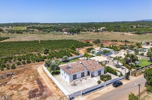 A residential area with a house featuring solar panels, a paved driveway, and a small garden. - Casa Gloria - Lovely farm house with private pool! (Alcantarilha)