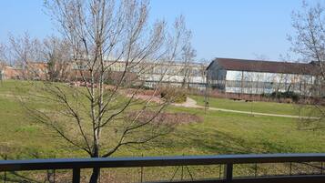 A view of a park with a building in the background.