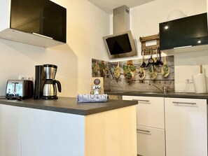 Fridge, stovetop, dishwasher, coffee/tea maker