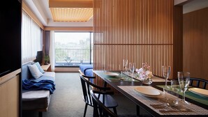 A modern dining area with a wooden partition, a sofa, and a balcony view. - Minn Nijo-jo (Kyoto)