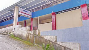 A building with a sign for "UTAMA Hotel & Karaoke."