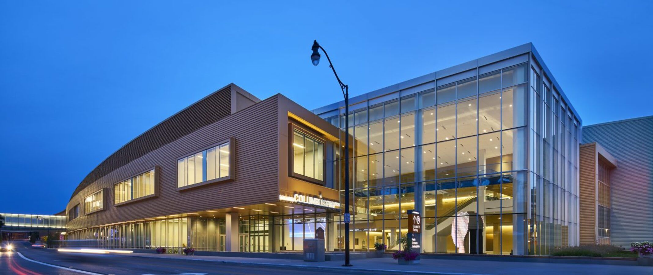 A modern building with a curved facade and large windows, likely a hotel or commercial property.