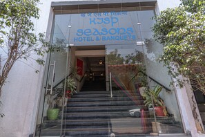 A hotel entrance with a sign reading "KJSP Seasons Hotel & Banquets" and a staircase leading inside. - KJSP SEASONS HOTEL (Navi Mumbai)