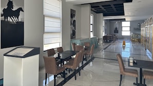 A spacious dining area with high ceilings and modern lighting fixtures. - ipsala park hotel (Ipsala)