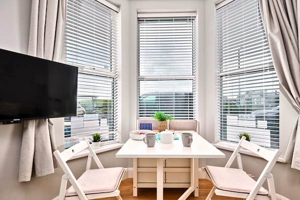 Relax in a serene space with a flat-screen TV, comfortable seating, and a peaceful view.