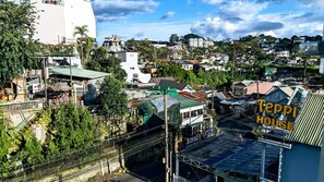 A densely built urban area with various buildings, including a prominent white structure and a green-roofed building. - VilLa 62 (Da Lat)