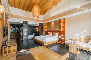 A modern hotel room with a large bed, a wooden ceiling, and a dining area with a table and chairs.