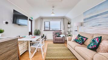 Deluxe Apartment | Living area | 40-inch TV with digital channels