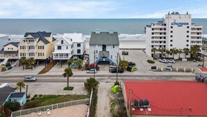 A coastal hotel with a beach view, multiple buildings, and a parking area. - Condo w/ Private Balcony & Stunning Views | Family Friendly (Garden City Beach)