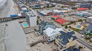 A coastal town with beachfront properties, a pier, and a variety of buildings including hotels and shops. - Condo w/ Private Balcony & Stunning Views | Family Friendly (Garden City Beach)