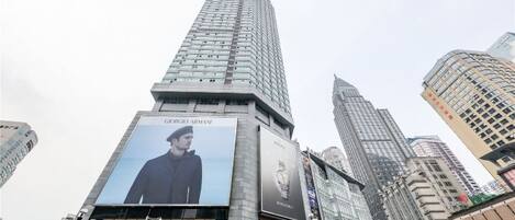 A tall building with a large billboard featuring a person.