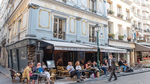 A café with outdoor seating, a sign reading "Au Rocher De Cancale," and a street view with pedestrians. - A PARISIAN LOFT LOCATED JUST FEW MINUTES FROM RUE MONTORGUEIL (Paris)