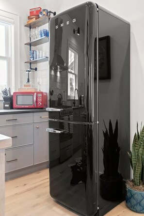 Enjoy cooking in this well-equipped kitchen with a refrigerator, microwave, and sink.