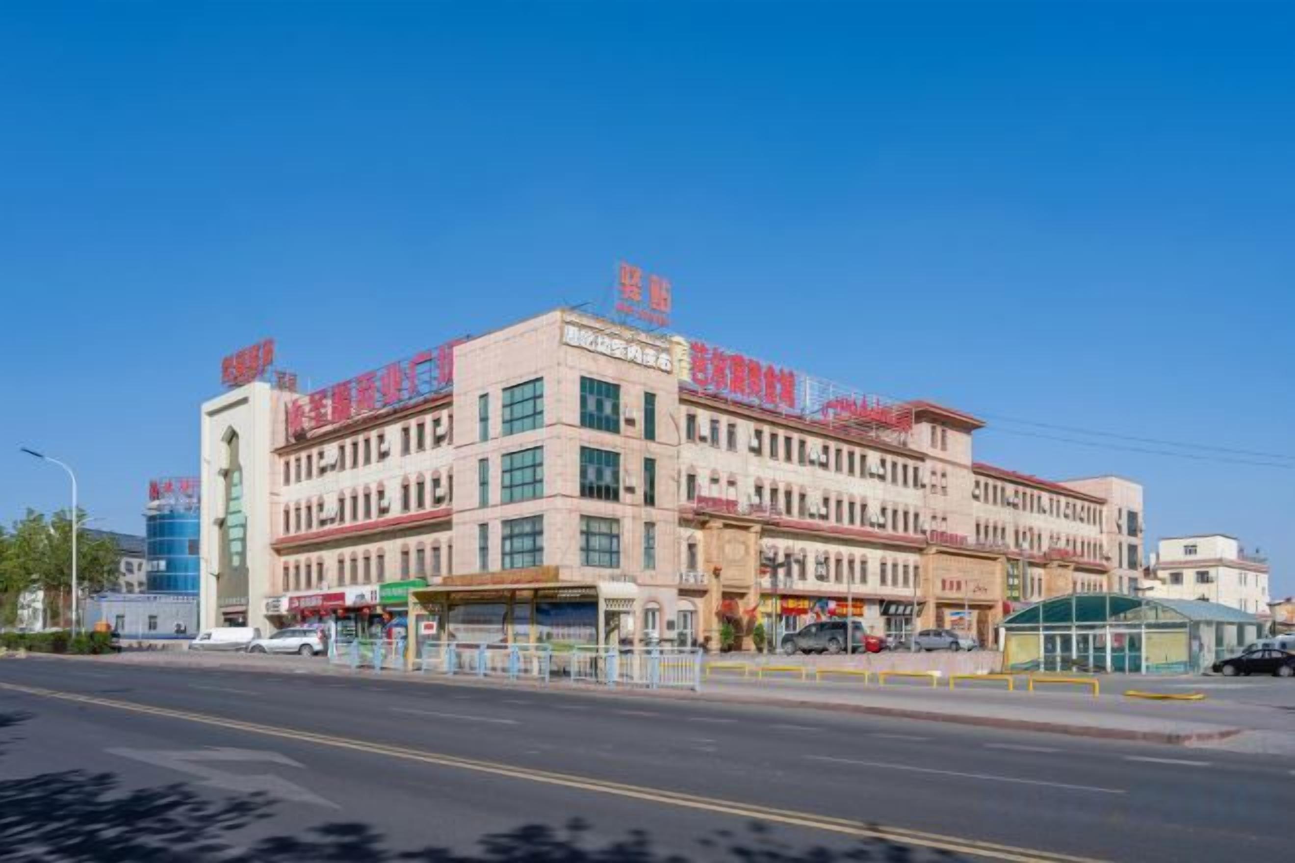 A multi-story hotel with a central atrium and multiple balconies.