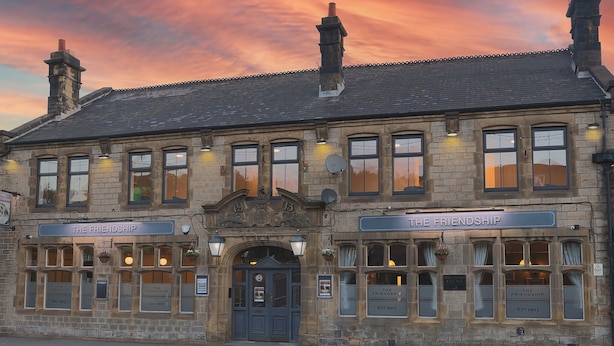 A historic building with the name 'The Friendship' prominently displayed. It features a traditional stone facade, multiple windows, and a classic entrance with a dark-colored door. - Friendship Hotel (Sheffield)