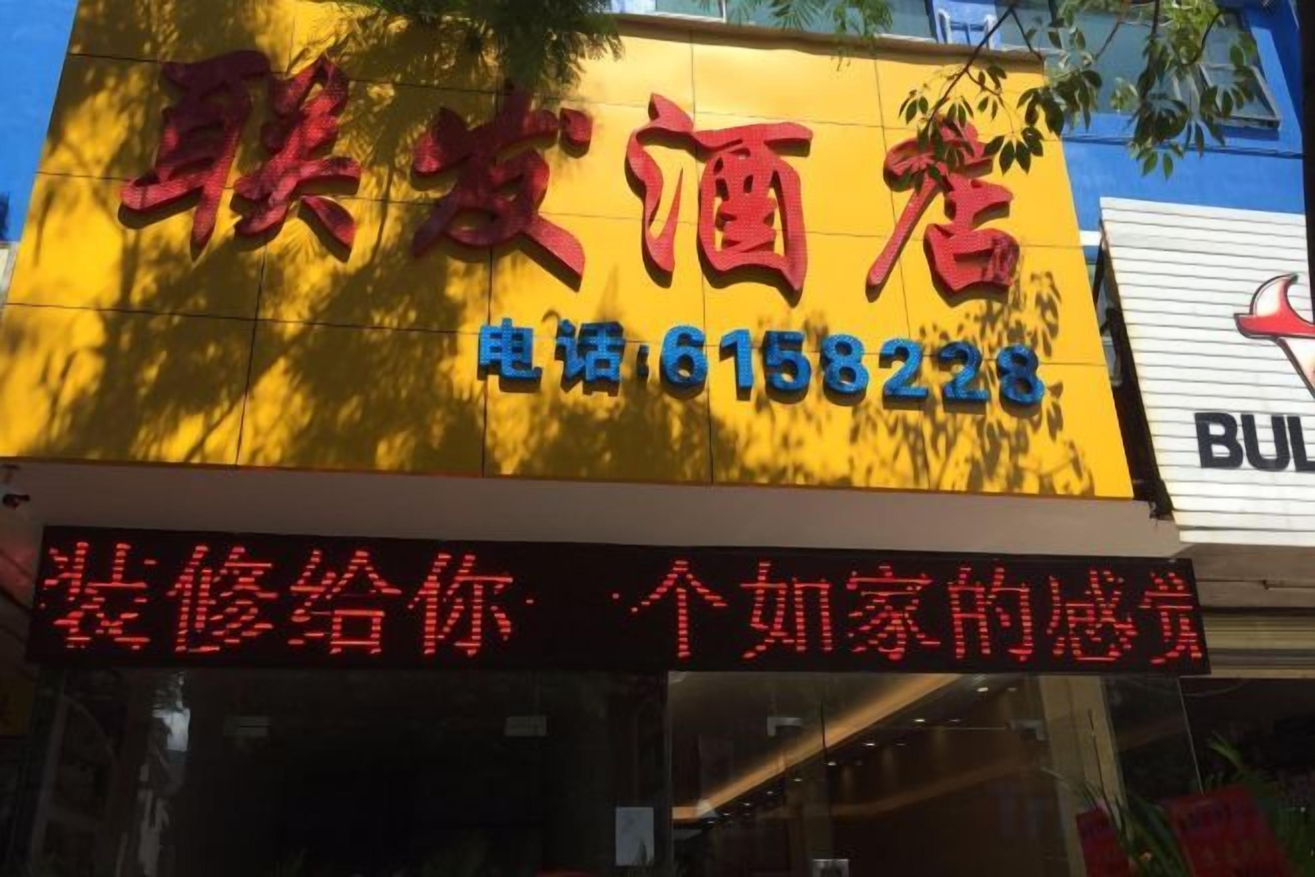 A hotel sign with a contact number and a message about room repairs.