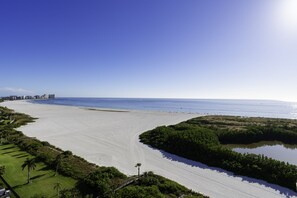 Guests can enjoy a serene beach experience with access to a calm ocean and lush surroundings.
