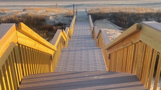 A wooden boardwalk leading to a beach with a clear view of the ocean. - Emerald Dream, Oceanside House in Emerald Isle, NC (Emerald Isle)