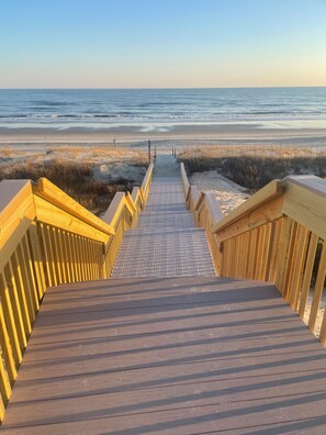A wooden boardwalk leading to a beach with a clear view of the ocean. - Emerald Dream, Oceanside House in Emerald Isle, NC (Emerald Isle)