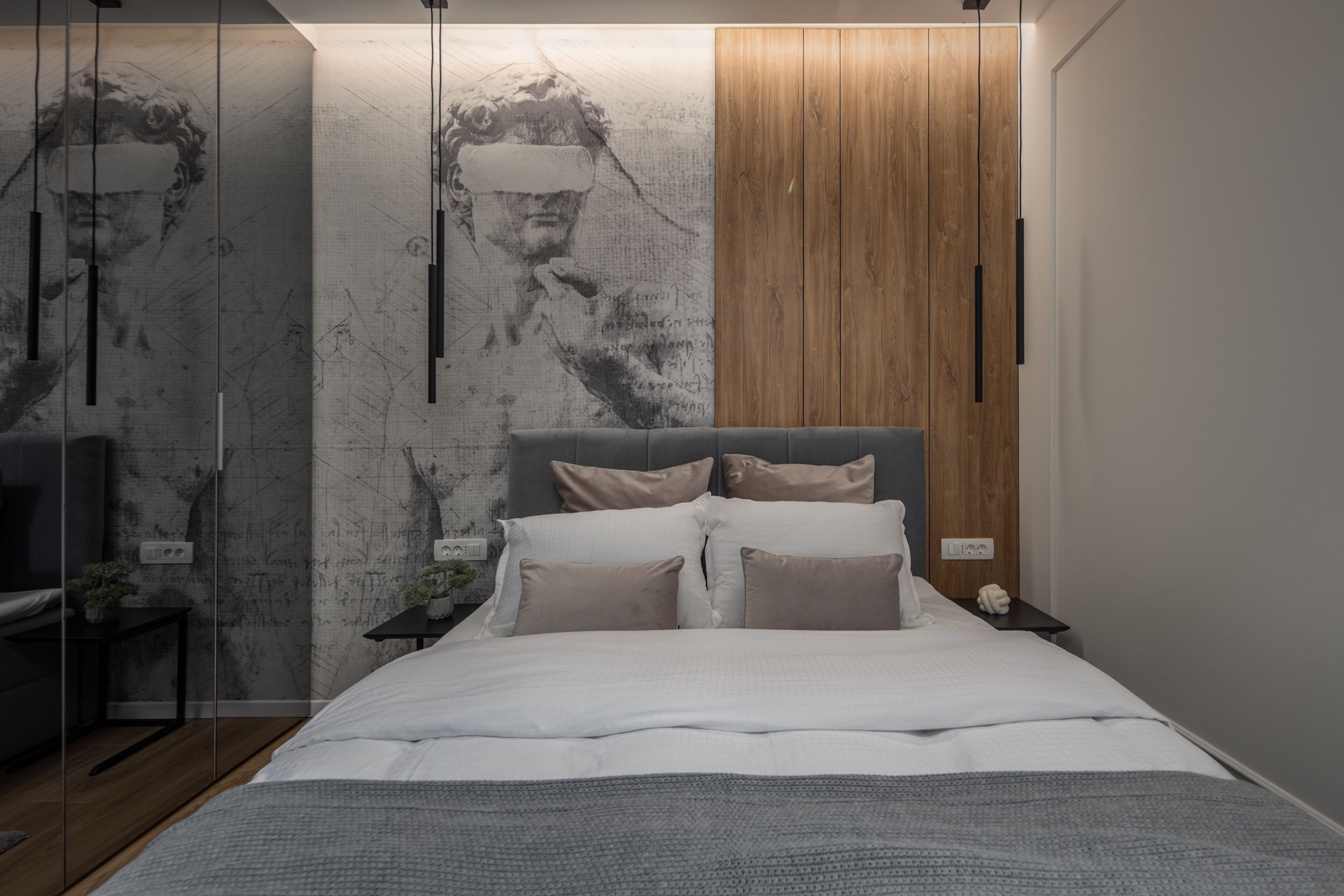 A modern bedroom with a large bed, wooden panel wall, and a mural.
