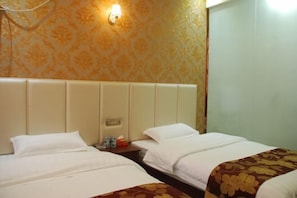 A hotel room with two beds, a headboard, a nightstand, and a wall-mounted light fixture. - Tashan Hotel (Langzhong)