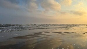 A beach with waves and a cloudy sky. - Blue Haven Beach!! (Freeport)
