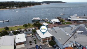 A waterfront property with a marina, a restaurant named 'The Boatshed', and a parking area. - Chic 2-bed Bridgeview Apartments Batemans Bay (Batemans Bay)