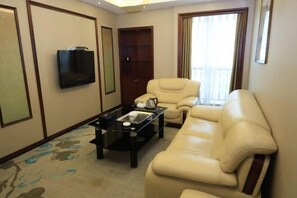 Relax in this stylish living room with a comfortable sofa, flat-screen TV, and ample storage.