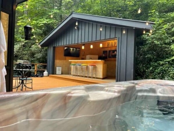 Relax in a peaceful retreat with a hot tub and bar area.