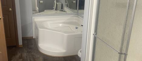 A bathroom with a bathtub, a shower, and a toilet.