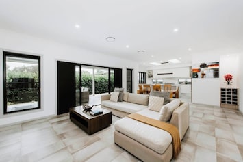 The spacious lounge area seamlessly flows out to the undercover patio and grassy backyard.