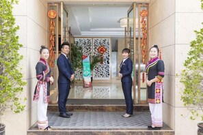 A hotel entrance with a modern design, featuring a glass door and decorative elements. - Yaju Hotel (Lancang)