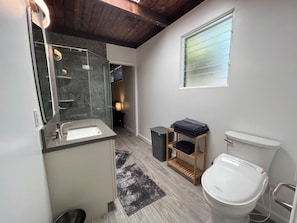 A bathroom with a sink, toilet, and a window. - Lovely Private Kailua Cottage (Kailua)