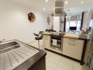 A modern kitchen with a stainless steel sink, a built-in oven, and a gas stove. - 2-room apartment at Le Moulin d'Or in downtown Lille, near the Lille Flandre train station (Lille)