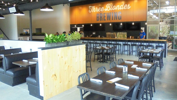 A restaurant interior with a wooden counter, multiple tables and booths, and a sign reading "Three Blondes BREWING". - Spacious Country Home & 15 minutes from Lake Michigan
 (Grand Junction)
