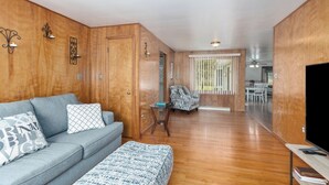 A living room with a grey sofa, patterned cushions, a small round table, and a patterned rug. - Spacious Country Home & 15 minutes from Lake Michigan
 (Grand Junction)